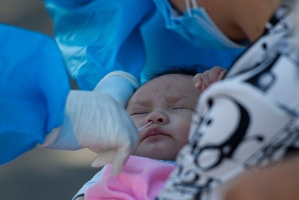 Tre bu me de phong Covid-19 hinh anh