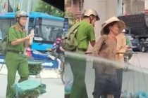 Nam sinh canh sat giua trua nang giup 2 ba cu ganh rau qua duong hinh anh